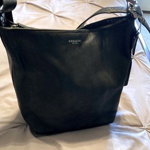 A beautiful black leather Coach purse. Able to store everyday essentials.